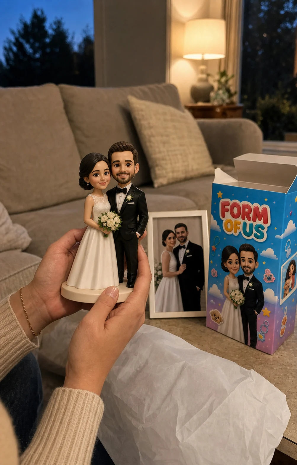 A personalized wedding figurine being held after unboxing
